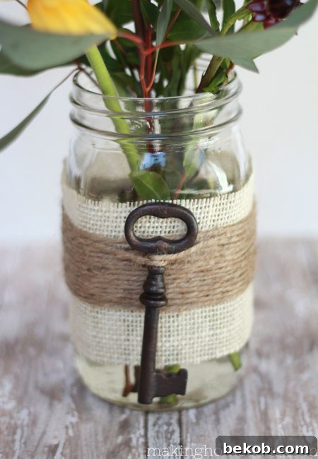 Embellished Mason Jar Vase by Making Home Base, offering rustic elegance on a budget.