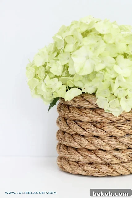 DIY Nautical Rope Vase from Julie Blanner, a simple elegant touch for coastal themes.
