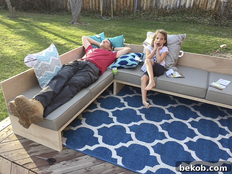 Husband relaxing on the new DIY outdoor sectional sofa with Better Homes and Gardens for Walmart cushions