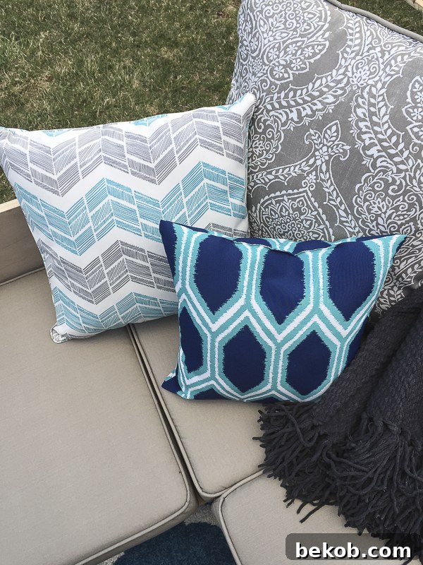 A cozy corner of the DIY outdoor sectional sofa with a chenille throw and throw pillows