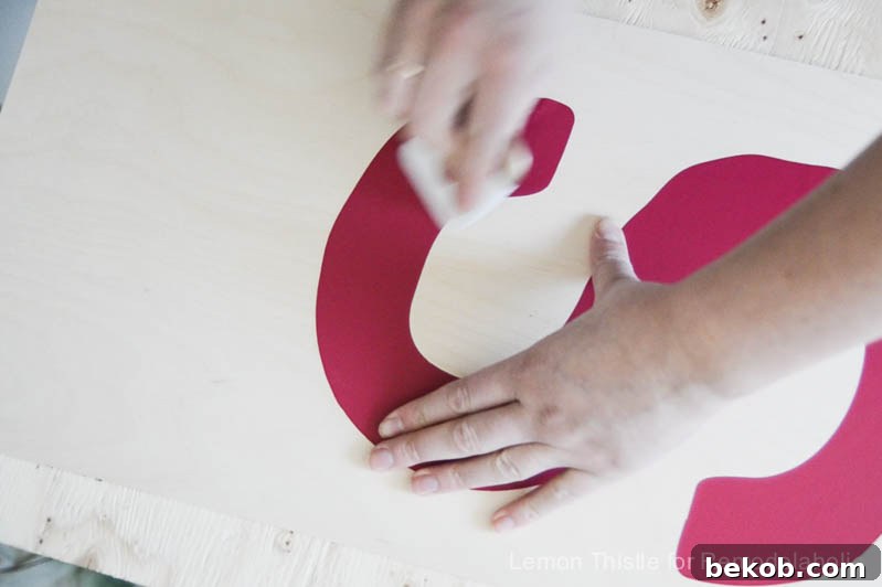 Rustic Stained DIY Plywood Monogram
Timeless Timber: A Personalized Plywood Monogram Project 6 Smoothing down the stencil on the plywood