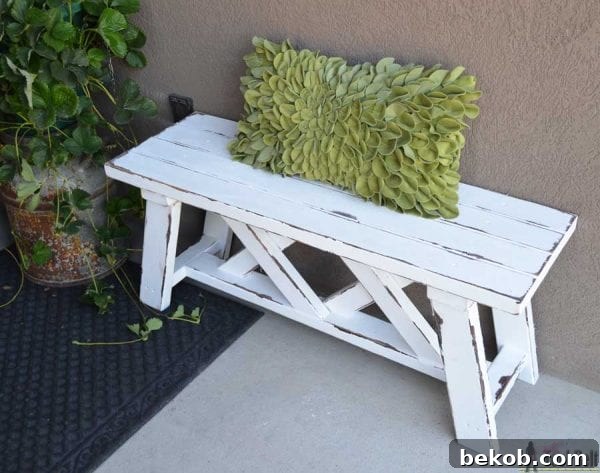 Sturdy outdoor bench with a unique double X design, built entirely from 2x4s. Ideal for garden or patio seating.