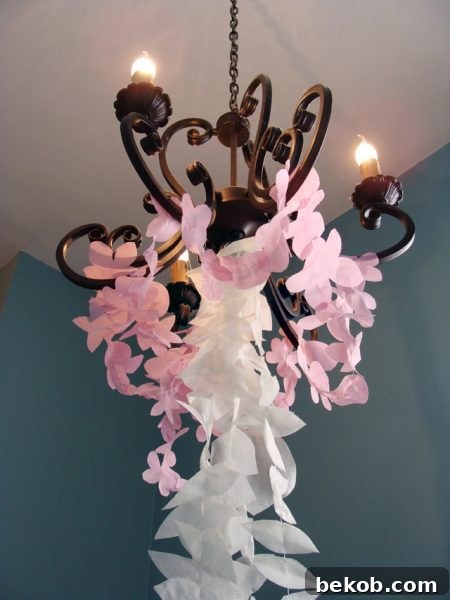 DIY Ethereal Cherry Blossom Garland made from disposable tablecloths hanging vertically in a stairwell.
