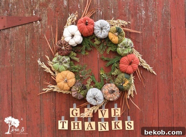 Colorful fabric pumpkin harvest wreath with mixed patterns and textures