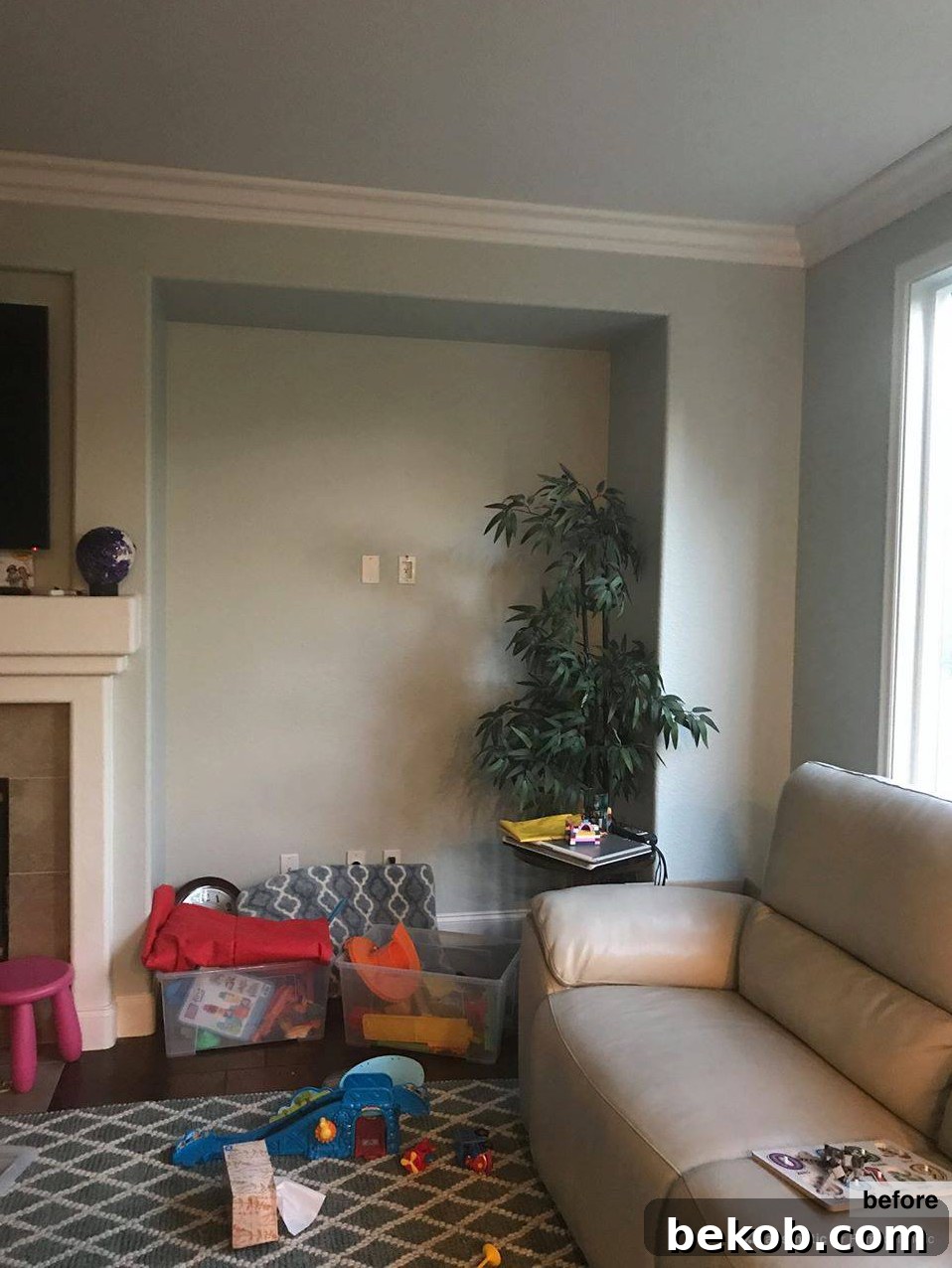 Before photo of an empty, awkward alcove in a family room, posing a design challenge for homeowners. Seeking creative nook decorating ideas to transform this unused space.