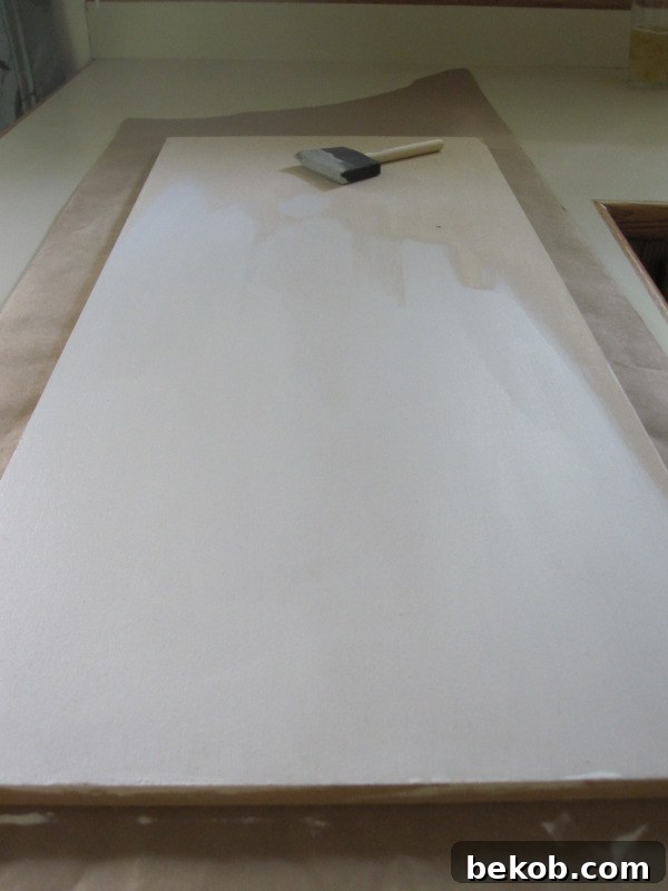 MDF board prepped for painting with a coat of primer applied