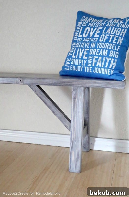 Woodworking Plans for a DIY wood bench with angled legs and farmhouse stain finish, perfect for various home settings