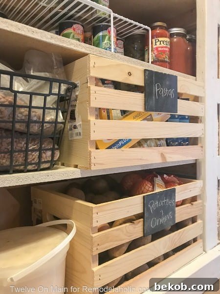 Wooden crates on lower shelves holding fruits and vegetables in an organized pantry