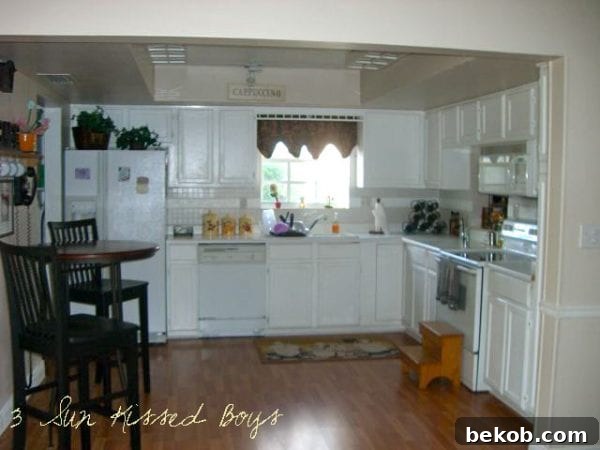 Before kitchen makeover with solid color cabinets, no hardware, by 3 Sunkissed Boys featured on Remodelaholic