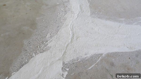Detailed View of Concrete Cracks Being Filled with DRYLOK Patch
