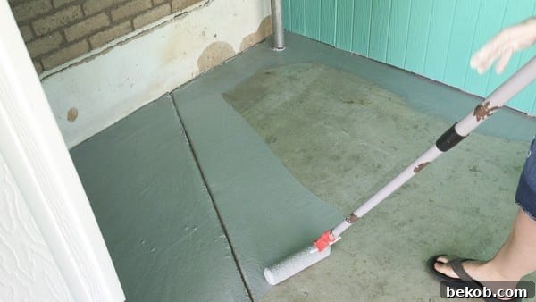 Rolling DRYLOK Epoxy Paint onto the Main Area of the Concrete Patio
