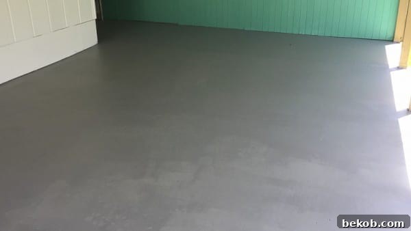 Mid-project view of painted concrete patio after the first coat