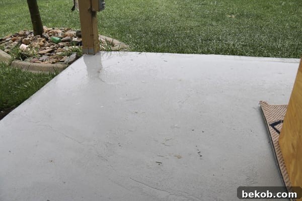 Painted Concrete Patio Holding Up After Rain and Snow, Showing Improved Drainage