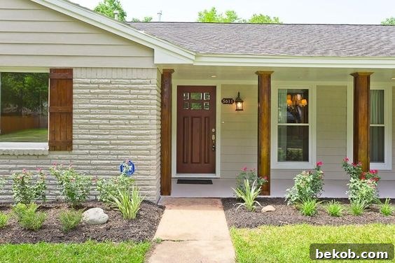 Contemporary ranch exterior with dark trim and strategic lighting, offering ideas for updating dated ranch homes.