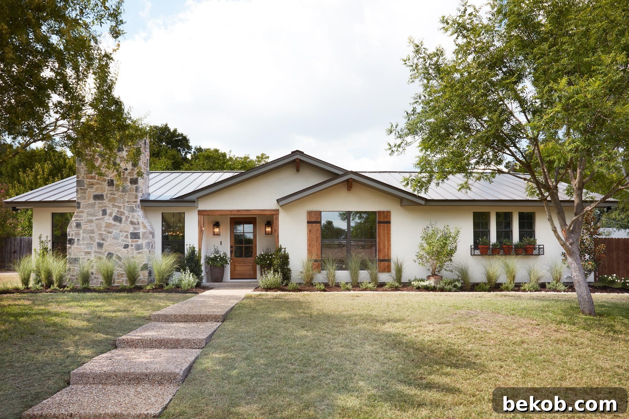 Expansive ranch home exterior with a sophisticated color palette and lush landscaping, a great example for exterior updates.