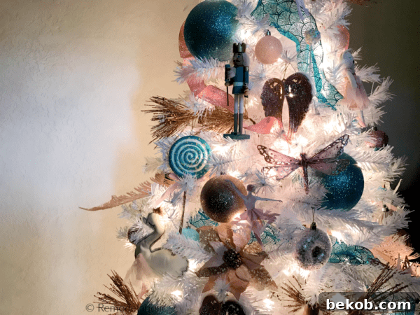 A magical Nutcracker themed Christmas tree by Remodelaholic, adorned in blue, gold, and pink pastels on a pristine white tree. Elegant and whimsical holiday decor inspiration. #remodelaholic #NutcrackerTree #WhiteChristmasTree