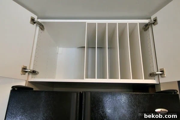 Ikea Hack DIY Over The Fridge Cabinet Organizer For Cookie Sheets And Cutting Boards #remodelaholic