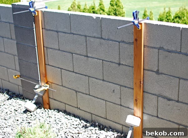 How To Attach Boards To A Cinder Block Fence To Make A Wood Slat Garden Wall With Planters, The Garden Glove Featured On Remodelaholic