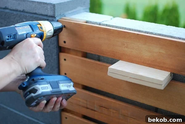 How to Install a DIY Wood Slat Garden Wall With Planters Tutorial, The Garden Glove Featured On Remodelaholic