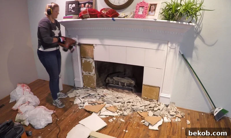 Removing old tile from a fireplace surround using a powerful hammer drill