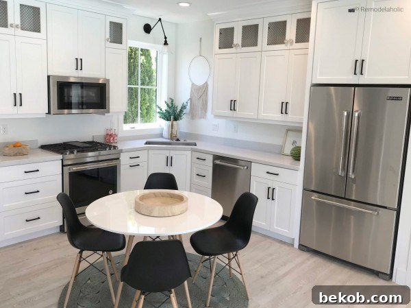 Black modern dining chairs in a white kitchen breakfast nook