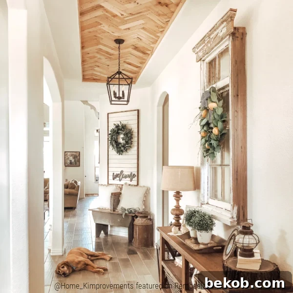 Close-up of a modern farmhouse entryway featuring a DIY pallet wood ceiling installed in a herringbone pattern within an inset tray ceiling, enhancing the home's character.