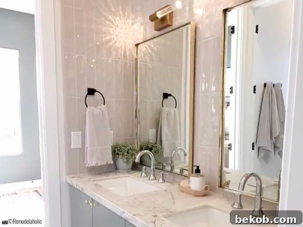 Stunning transitional Jack and Jill bathroom with a green vanity and marble countertops, featuring sleek design by Salt Box Collective.