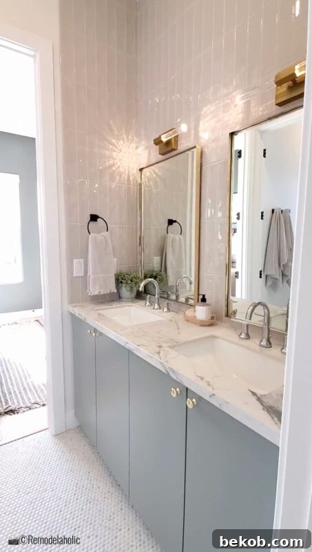 Double vanity with unique gold lighting and symmetrical mirrors in a transitional Jack and Jill bathroom.