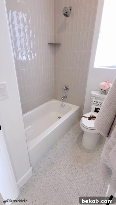 Stylish green vanity cabinet with slab style doors in a modern transitional shared bathroom.