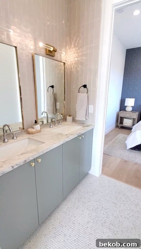 Bathroom vanity with elegant marble style countertop complementing a green cabinet.