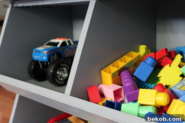 A sturdy wooden toy box with multiple cubbies for organized storage.