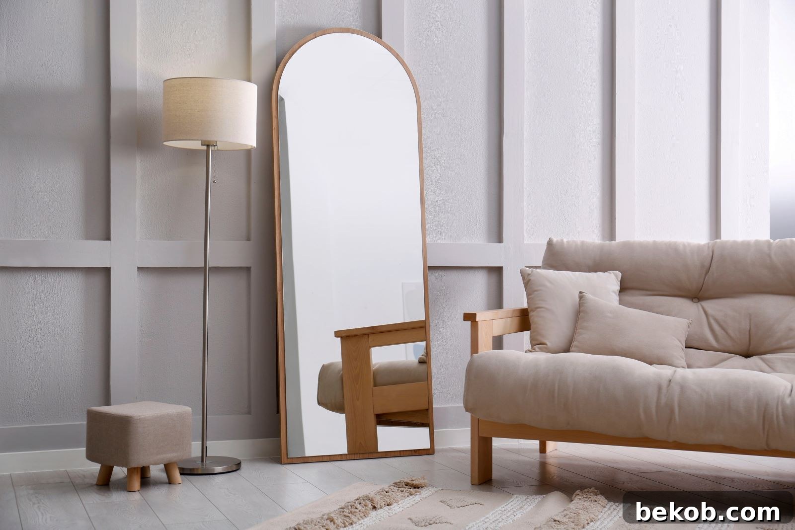 Large mirror reflecting light in a modern small living room, making it appear larger and brighter. A strategic design hack for compact interiors.