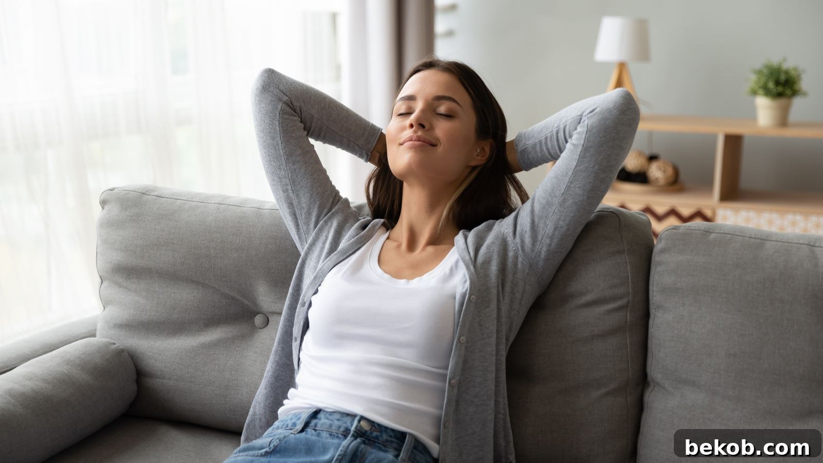 Happy woman relaxing in a beautifully refreshed home interior, symbolizing the big impact small changes can make in a living space.