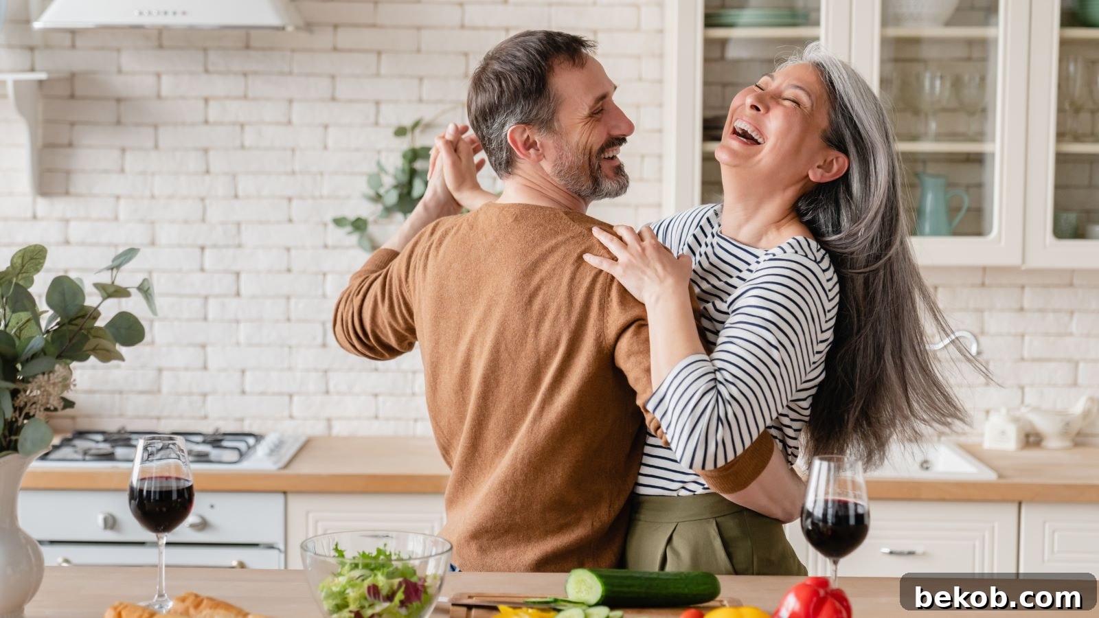 Happy couple enjoying their modern and efficient tiny kitchen, showcasing smart design for compact culinary spaces.