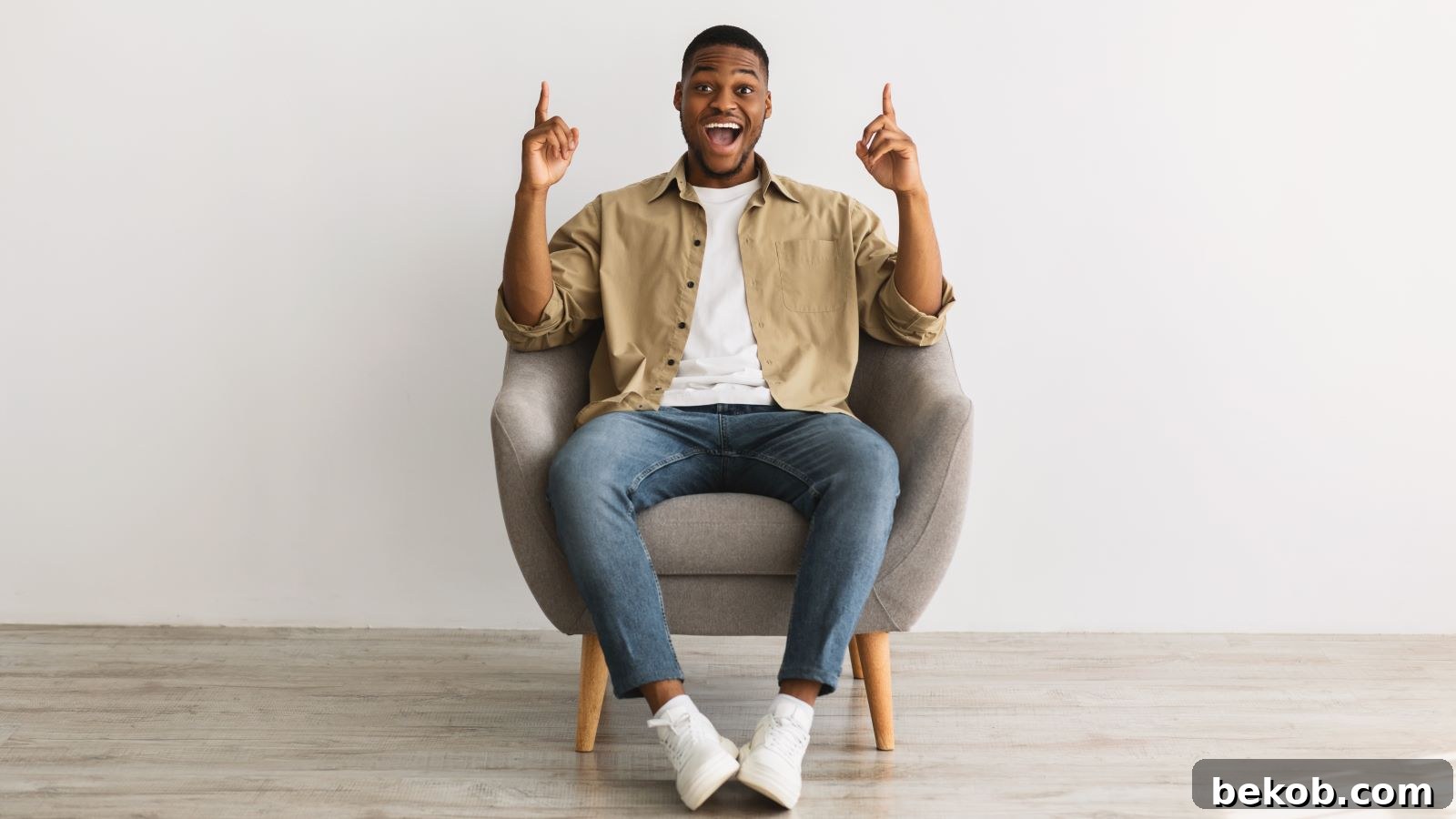 Happy man enjoying a peaceful, uncluttered minimalist space, symbolizing the positive impact of embracing a simpler life.