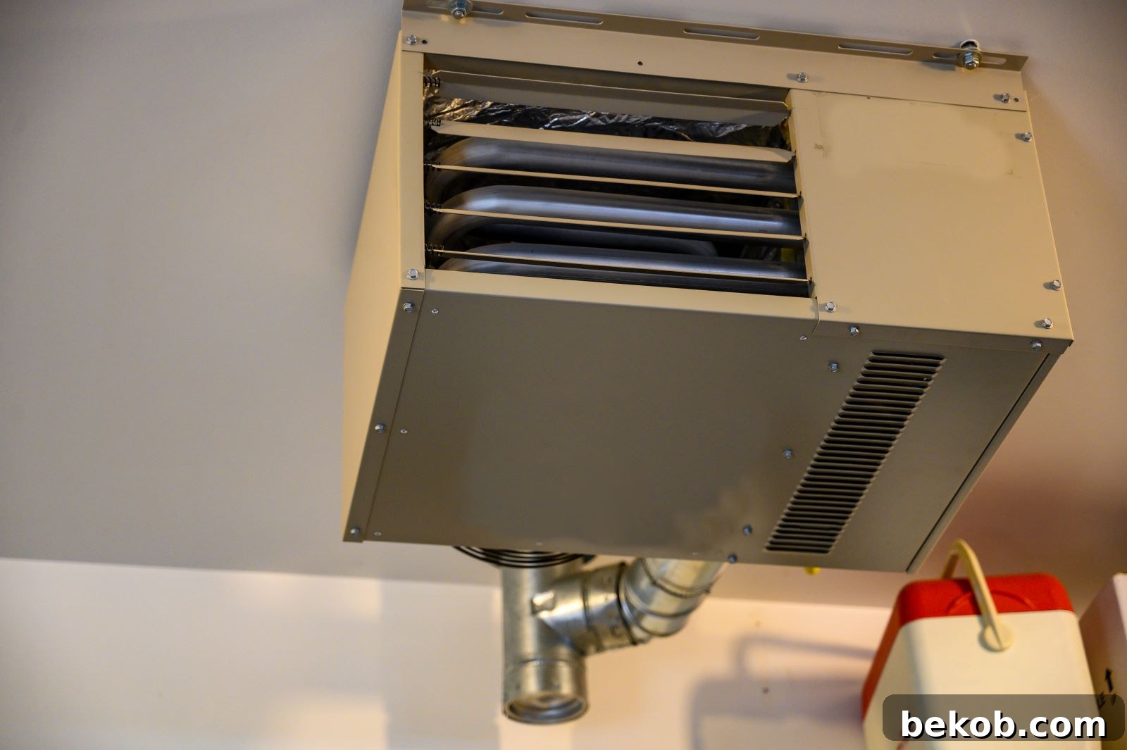 Modern garage heater mounted on a wall in a well-insulated finished garage, showing climate control for comfort.