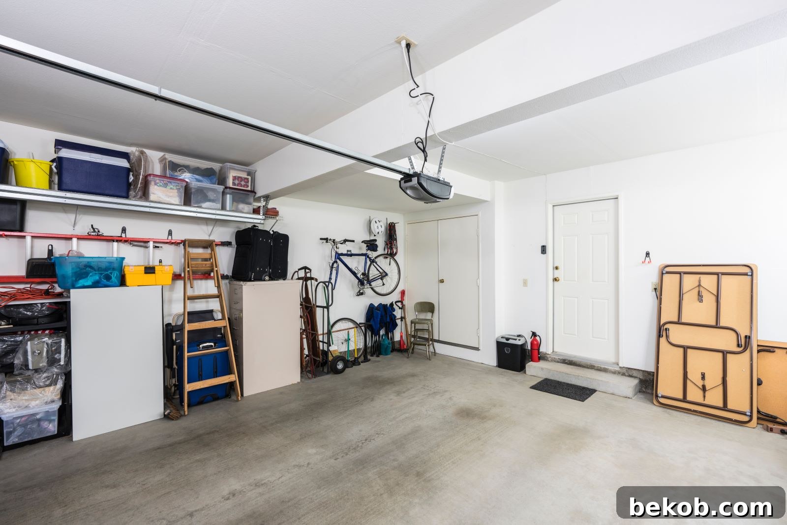 A modern garage space featuring a foldable wall-mounted desk and versatile seating, showcasing multi-purpose furniture for small spaces.