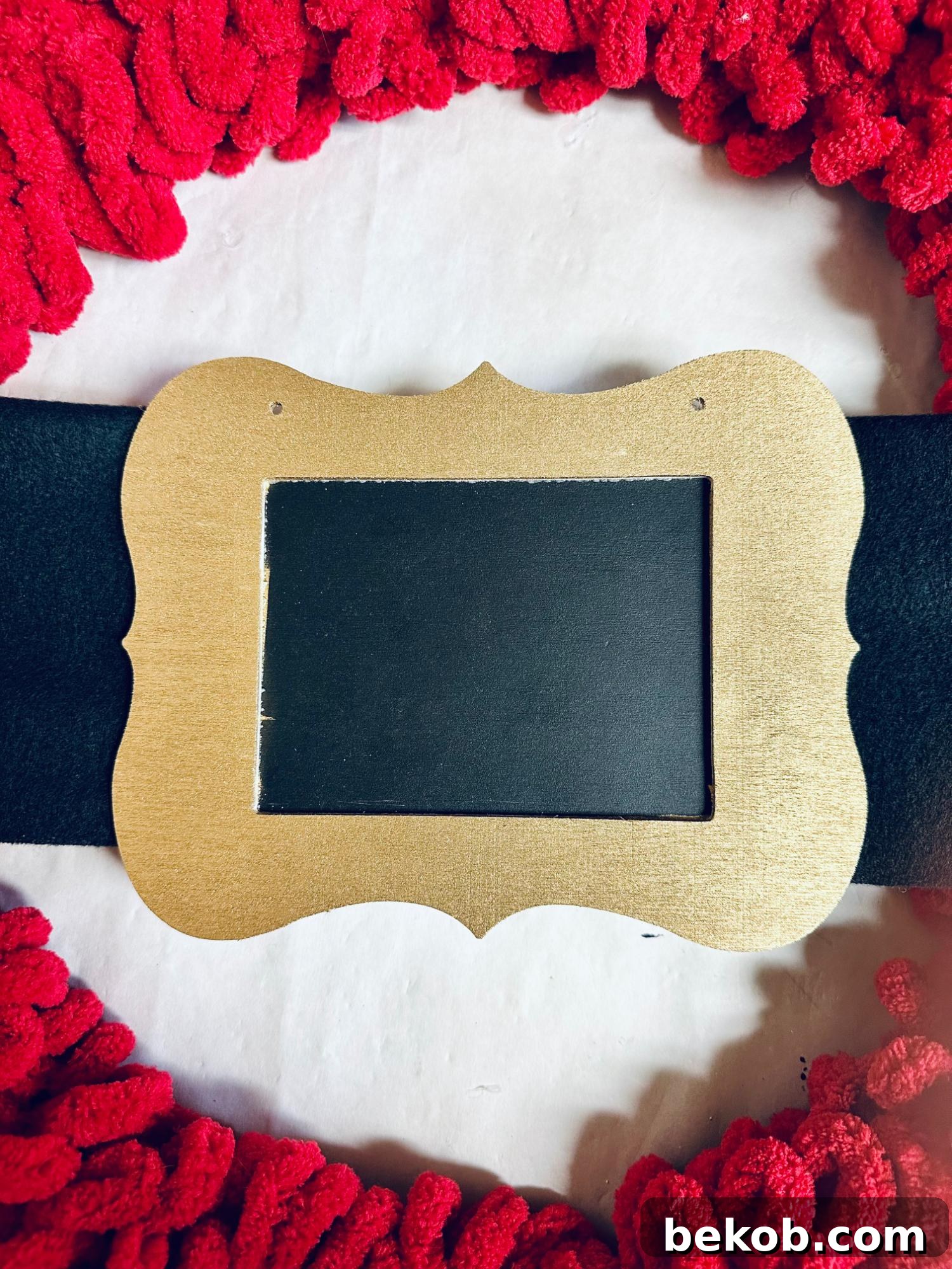 Close-up of the Santa Belt Wreath buckle secured to the scarf