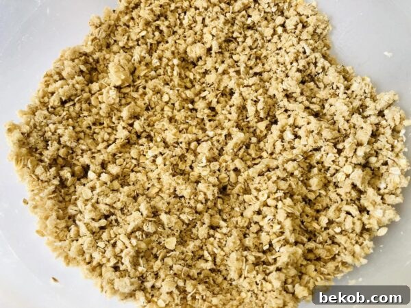 Adding softened butter to the oat mixture.
