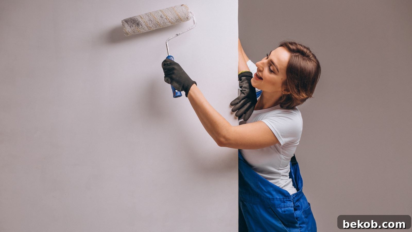 Girl Painting Wall Using Roller