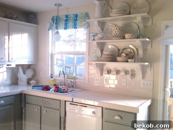 Close-up of kitchen cabinets being painted from oak to white, showing detailed work