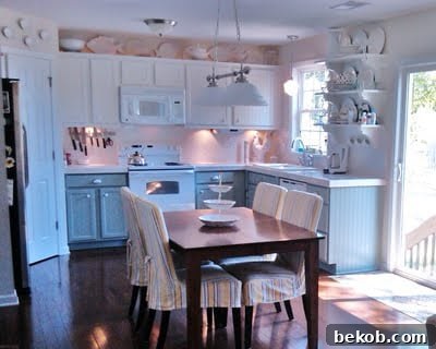 Final look of the renovated kitchen with gray and white painted cabinets, featuring Silver Mink by Benjamin Moore and Natural Choice by Sherwin Williams