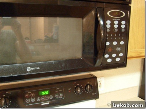 The original kitchen microwave, covered in a visible layer of filmy grease.