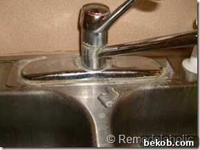 Another view of the original kitchen sink, highlighting its shallow depth and general lack of cleanliness.