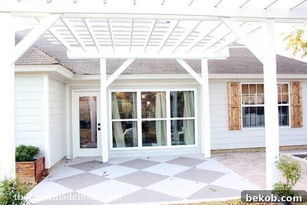 Update and beautify a concrete patio by The Handmade Home, featuring a beautifully painted diamond pattern.