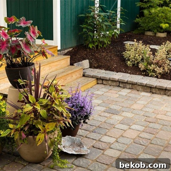 How To Design And Build A Paver Patio Via Lowe's - A stunning example of a concrete patio enhanced with beautiful paver designs.