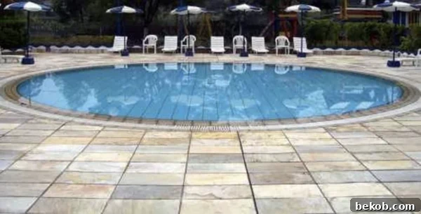 Install Slate Tile Over Concrete By Hunker - A beautiful example of slate tiles transforming a concrete patio into an elegant outdoor space.