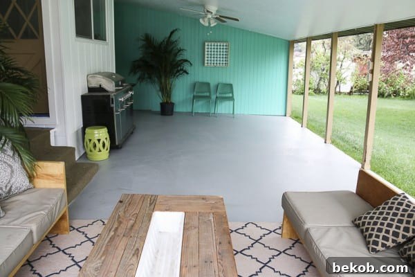 Painting A Patio With UGL Epoxy Floor Paint @Remodelaholic 37 - A vibrant, painted concrete patio showcasing elegant outdoor dining furniture and decor.