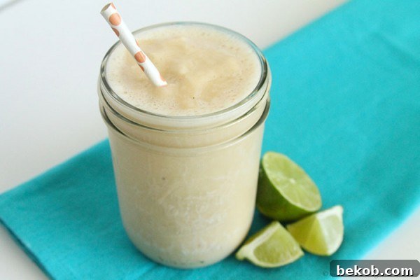 Tropical Smoothie served in a glass with a straw, ready to be enjoyed