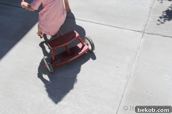 Girls Riding Toys on New Concrete Patio